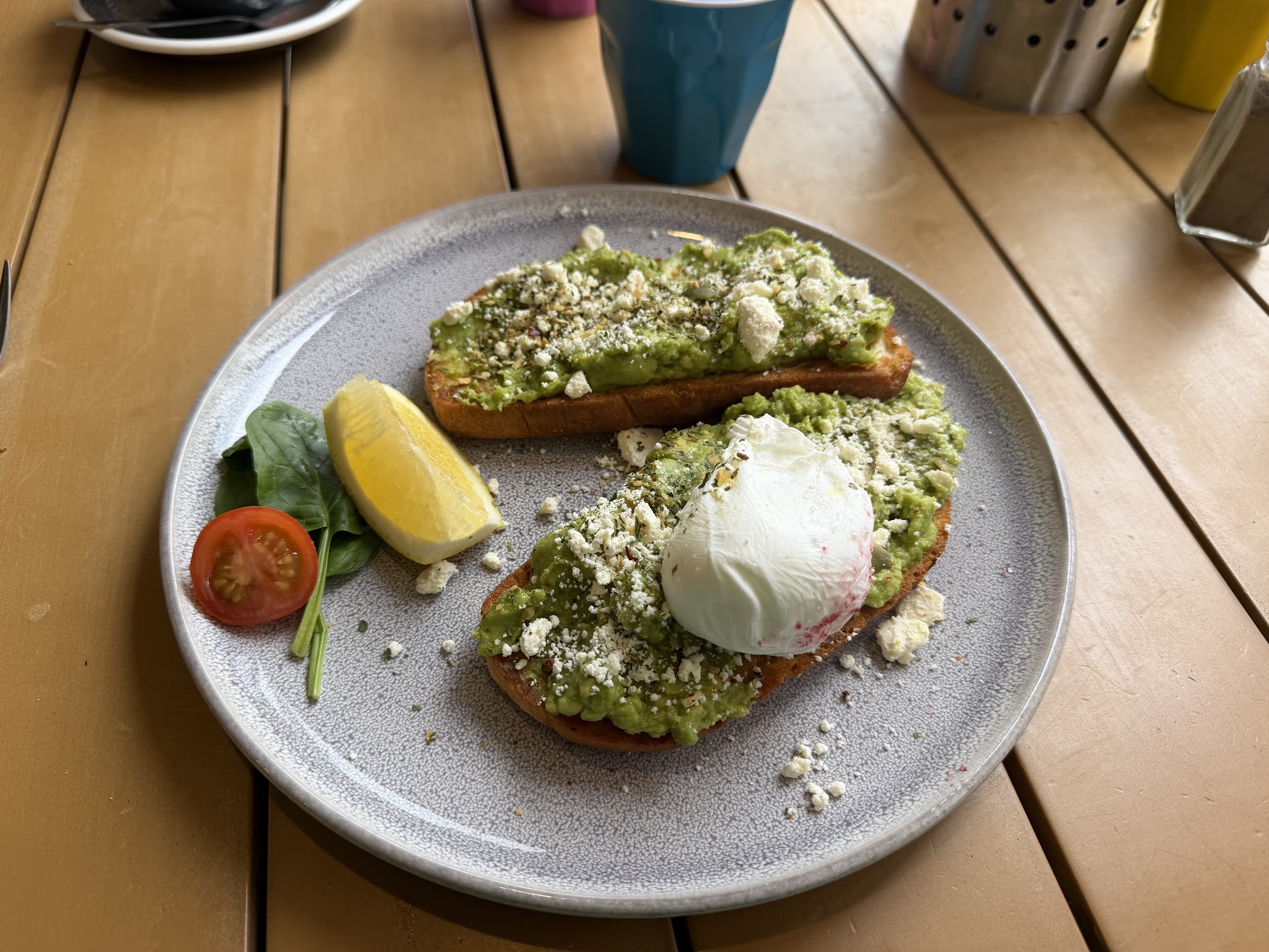 Smashed avocado on toast with feta and a poached egg